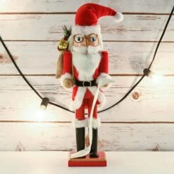 14 In. Wooden Christmas Santa Nutcracker Santa In Traditional Attire W/ A Bag Of Gifts On His Shoulder And List Of Names -The Home Depot Shop christmas figurines or 220 4f 1000