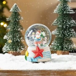 5.12 In. H Christmas Resin Musical Snowflakes Santa On Vacation Waterglobe -The Home Depot Shop glitzhome christmas figurines 2040300008 31 1000